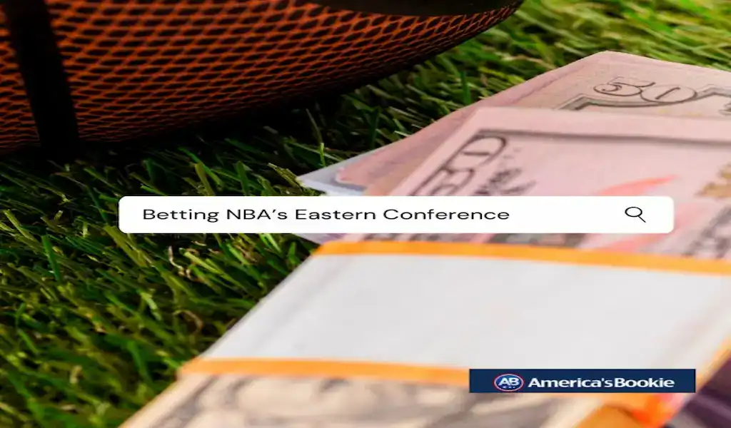 Stack of cash on grass beside a basketball representing NBA Eastern Conference betting at online sportsbooks.