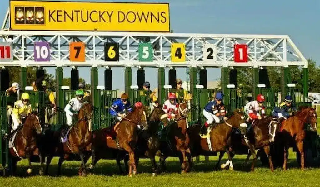 Gambling News 10 Horses leaving the starting gate at Kentucky Downs during a sunny afternoon race day.