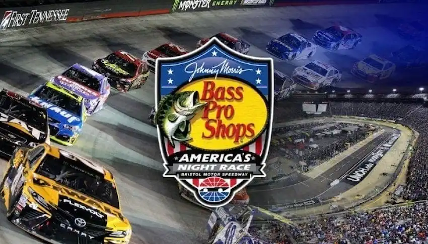 Racing cars speeding around a brightly lit track in the background.