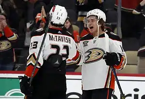 Danton Heinen, left, celebrates with a teammate after a successful play during a hockey game.