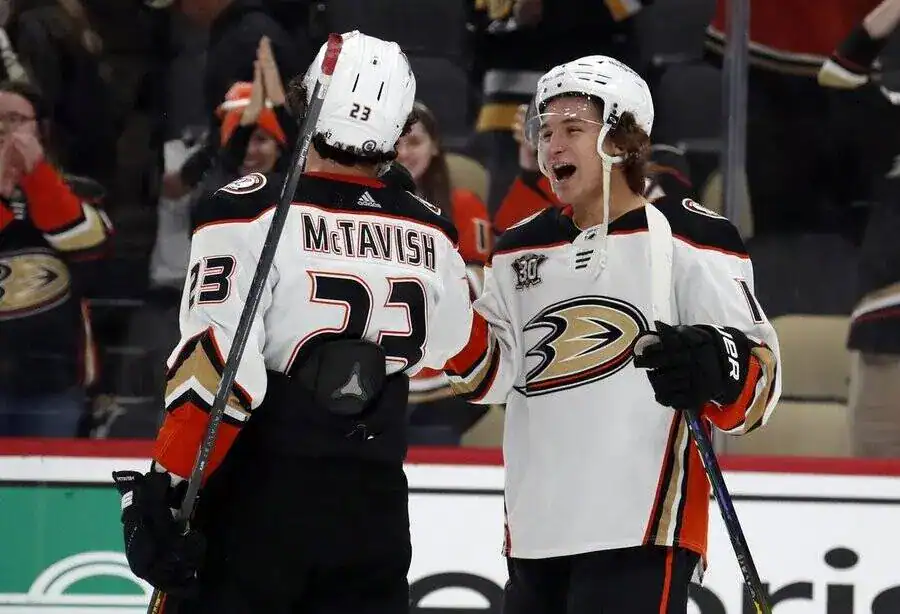 NHL 10 Danton Heinen, left, celebrates with a teammate after a successful play during a hockey game.