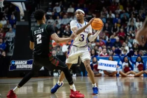 A Kansas Jayhawks player prepares to pass the basketball.