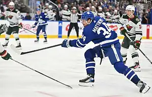 Toronto Maple Leafs forward Auston Matthews takes a shot on goal against the Minnesota Wild defense.