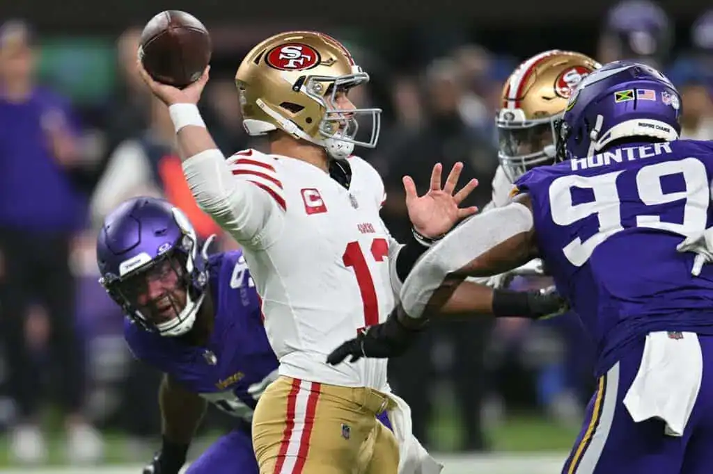 San Francisco 49ers quarterback throws under pressure from Vikings.