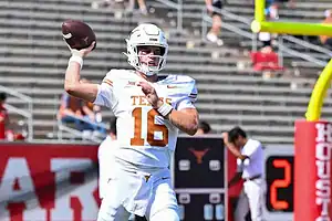 Texas Longhorns quarterback throws a pass during a college football game.