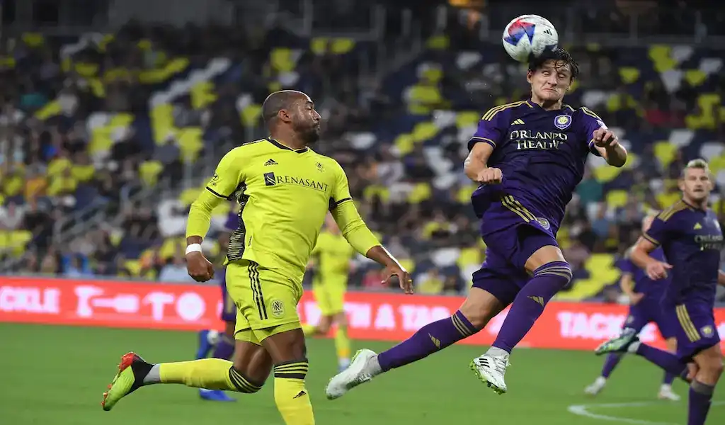 Toronto FC player battles Orlando City SC defender for the ball during MLS match on October 21, 2023.