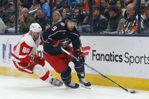 columbus blue jackets player with calgary flames player behind