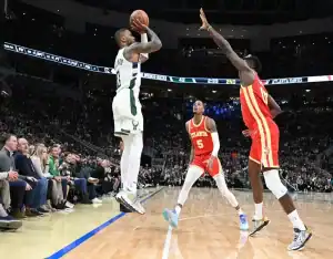 Milwaukee Bucks player shoots over Atlanta Hawks defenders ahead of October 30, 2023 matchup vs Miami Heat
