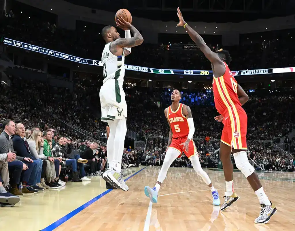 Milwaukee Bucks player shoots over Atlanta Hawks defenders ahead of October 30, 2023 matchup vs Miami Heat