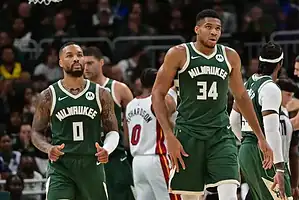 Milwaukee Bucks stars Damian Lillard and Giannis Antetokounmpo walk together during a game.