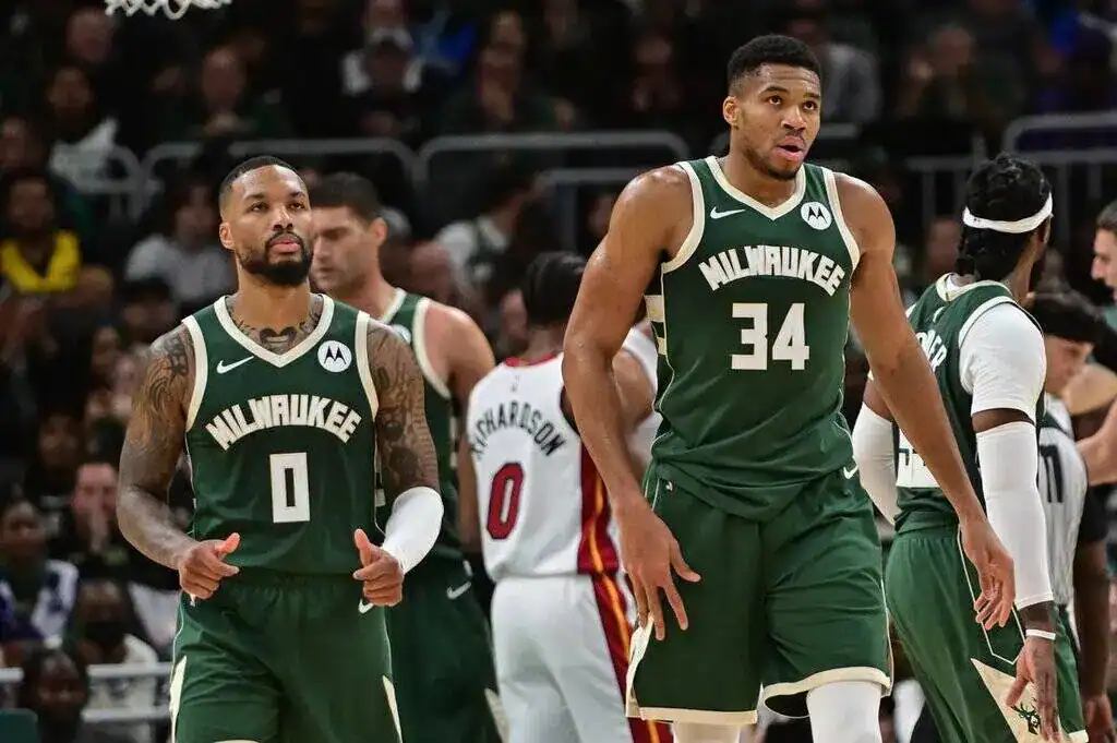 Milwaukee Bucks stars Damian Lillard and Giannis Antetokounmpo walk together during a game.