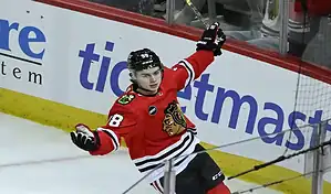 Chicago Blackhawks player celebrates after scoring a goal against the New Jersey Devils during an NHL game.