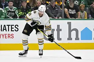 Boston Bruins player Karl Marsson in action on the ice during a hockey game, wearing team colors and gear.