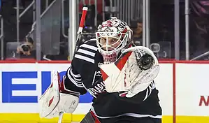 New Jersey Devils goalie makes a glove save during a November 25, 2023, NHL game against the Buffalo Sabres.