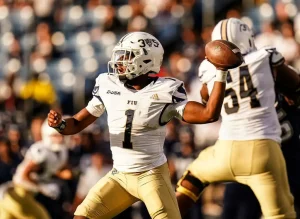 FIU Panthers quarterback, winds up to throw a pass during a college football game.