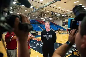 Florida Atlantic coach speaks to media in gym.