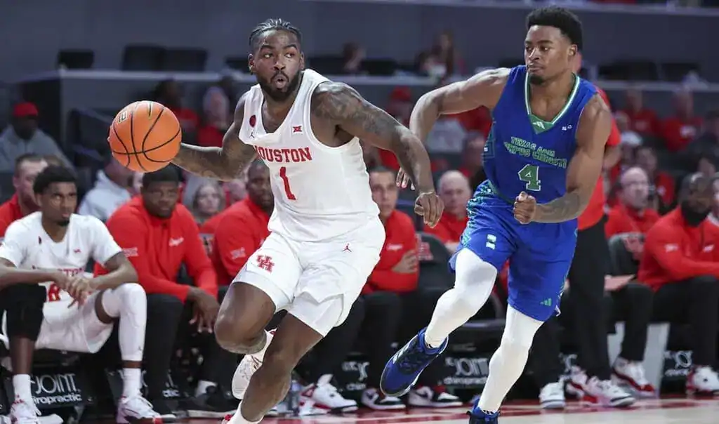 Houston guard dribbles past a defender with speed during a transition play