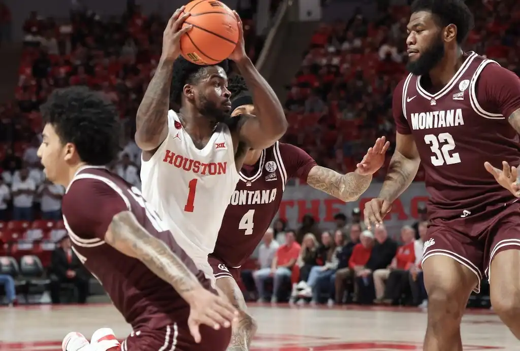 NCAAB 6 A Houston basketball player holds the ball above his head.