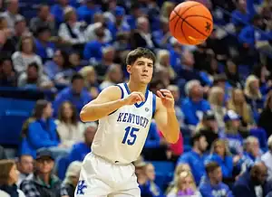 Kentucky Wildcats player wearing jersey number 15 passes the ball during an NCAA basketball game.