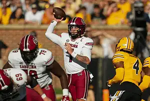 South Carolina quarterback throws pass against Missouri defense.