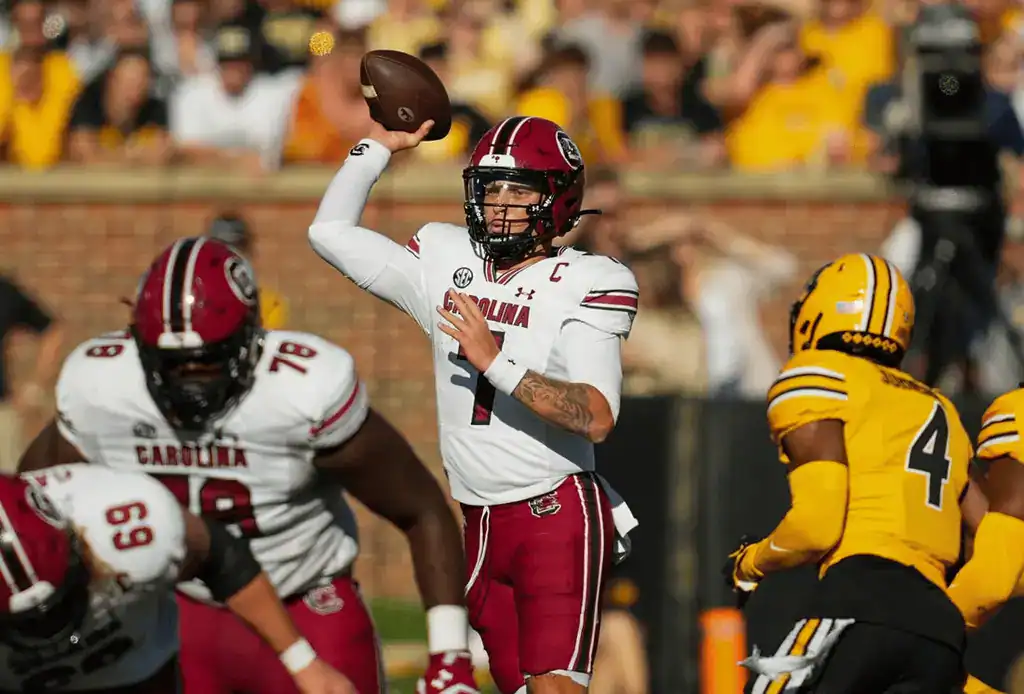 South Carolina quarterback throws pass against Missouri defense.