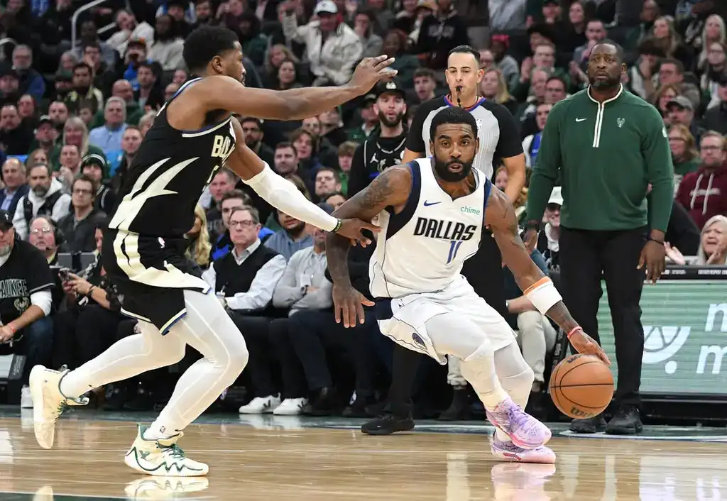 Kyrie Irving of the Dallas Mavericks drives past a defender during an NBA game
