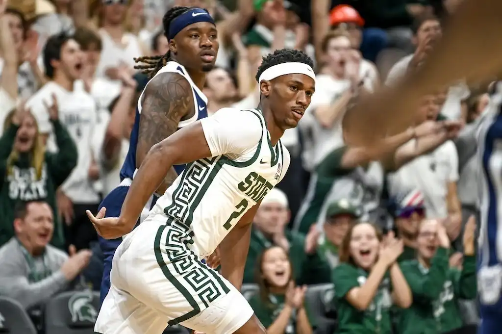 NCAAB 7 A Michigan State basketball player celebrates after a big play.