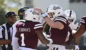 Mississippi State Bulldogs football players celebrate during a game against the Mississippi Rebels on November 23, 2023.