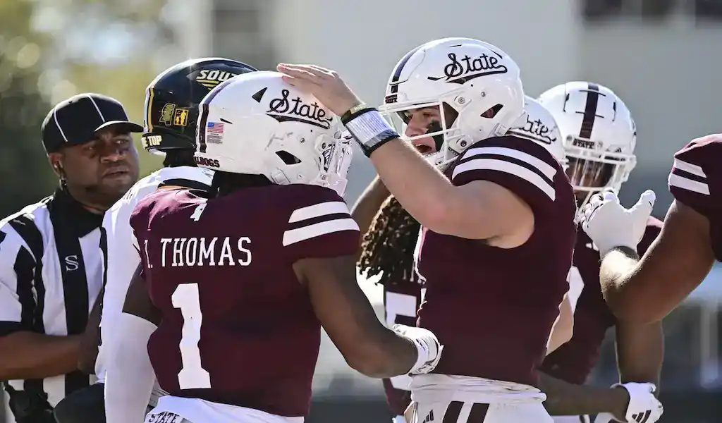 Mississippi State Bulldogs football players celebrate during a game against the Mississippi Rebels on November 23, 2023.