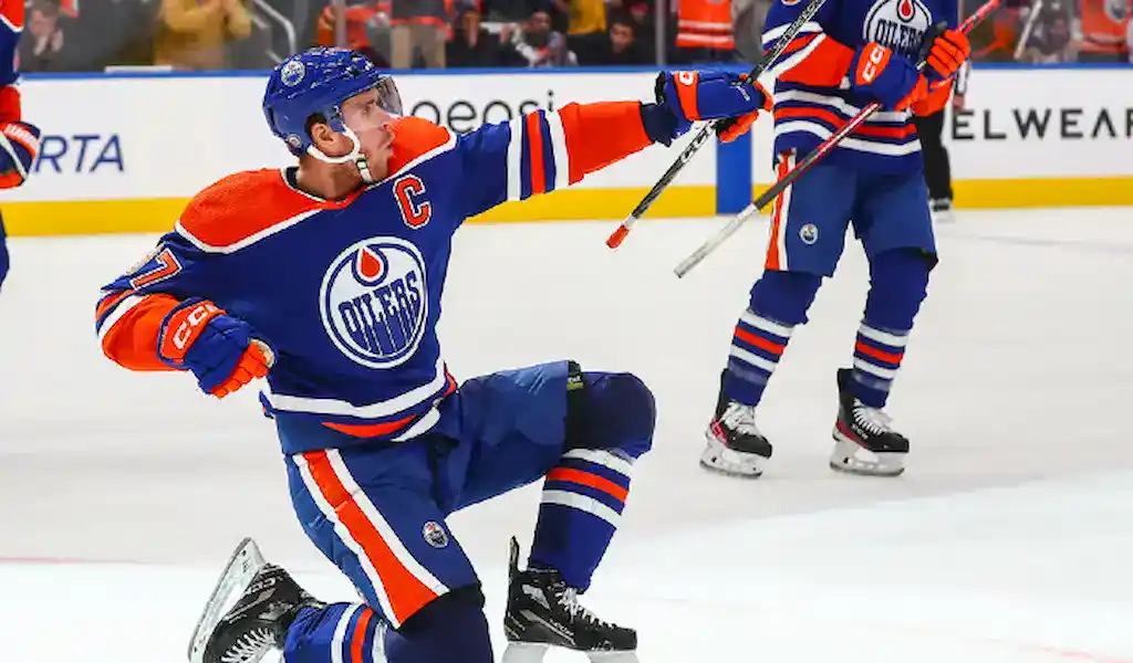 Edmonton Oilers captain Connor McDavid celebrates after scoring a goal during an NHL game, showcasing key players for NHL awards futures.