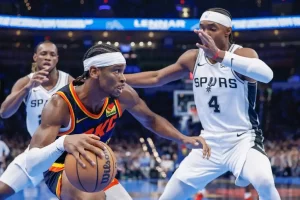 An Oklahoma City basketball player drives toward the basket.