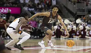 Oklahoma Sooners guard dribbles past a Central Michigan defender during their NCAA basketball matchup on November 6, 2023.