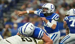 Indianapolis Colts quarterback throwing a pass during an NFL game against the New Orleans Saints.