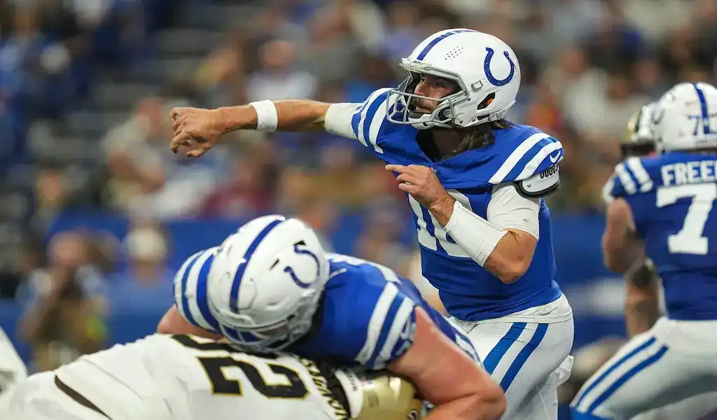 Indianapolis Colts quarterback throwing a pass during an NFL game against the New Orleans Saints.
