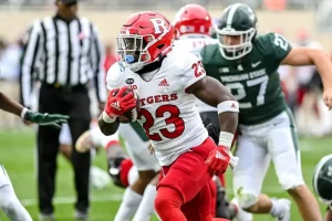 Rutgers running back carries the football upfield during a game.