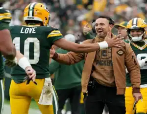 Green Bay Packers coach celebrates with Jordan Love during NFL game vs. Steelers