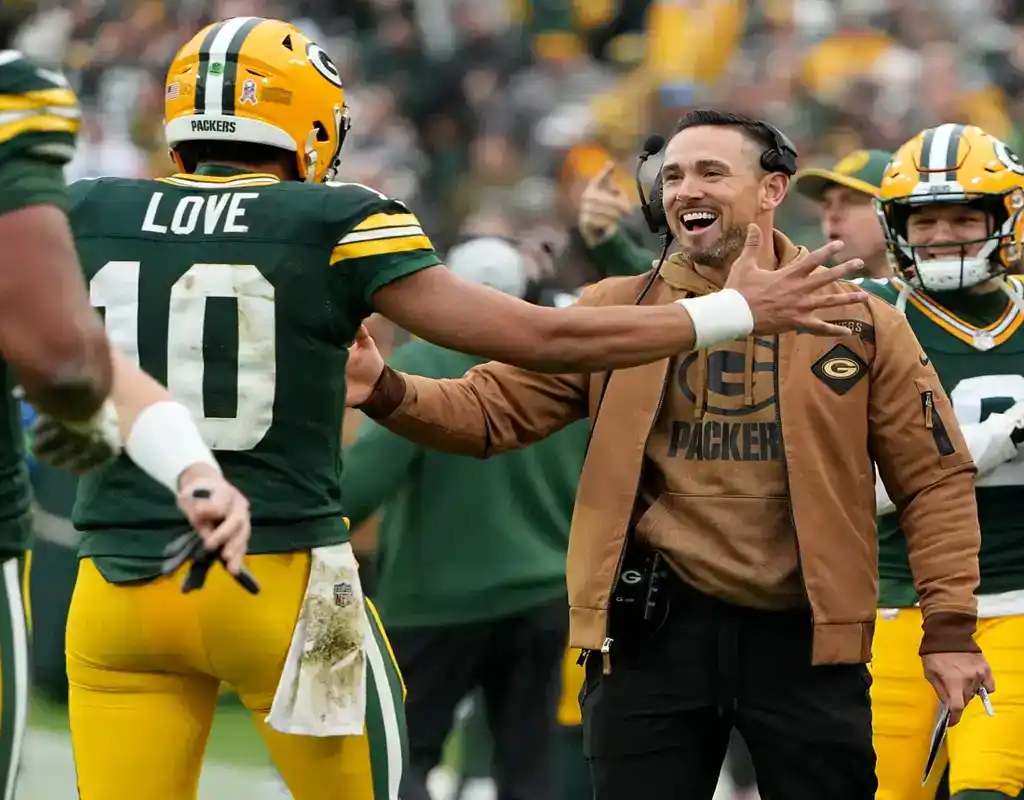 Green Bay Packers coach celebrates with Jordan Love during NFL game vs. Steelers