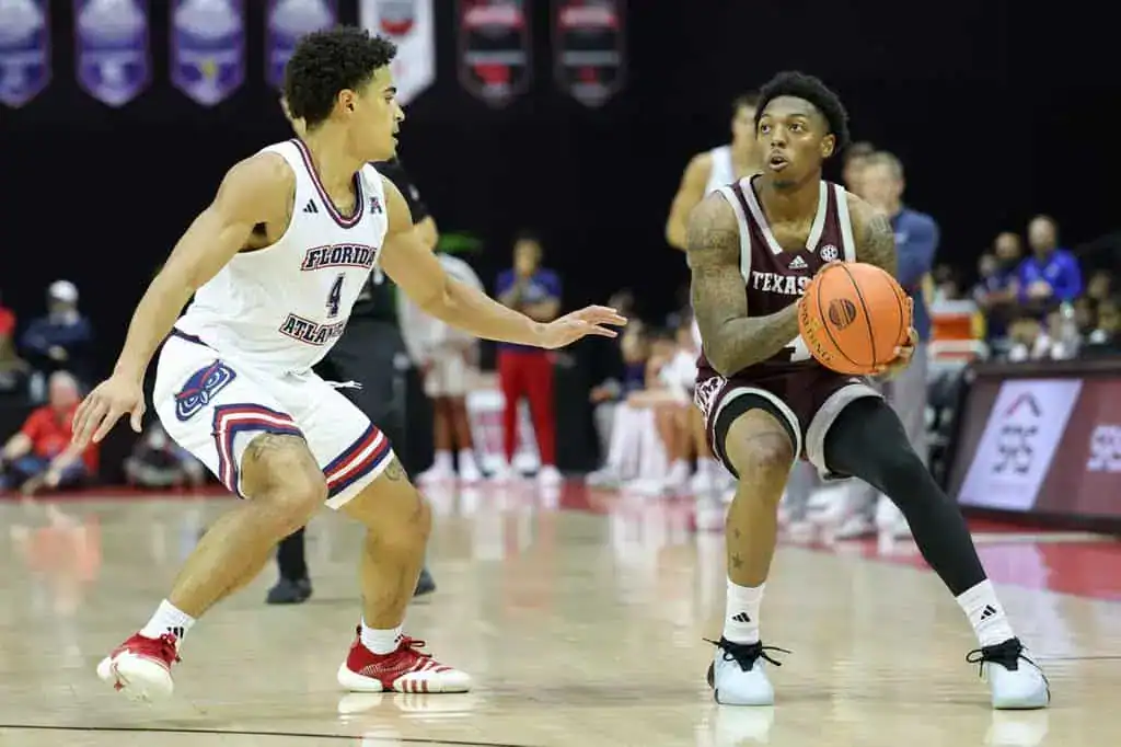 Texas A&M guard squares up for a jump shot while being guarded by a Florida Atlantic player.