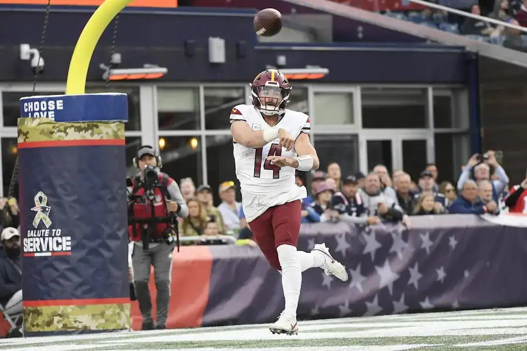 Washington Commanders quarterback Sam Howell throws a pass during a game.