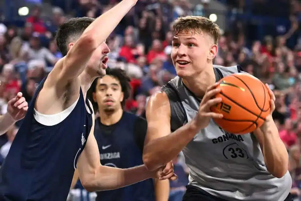 Gonzaga player drives to the basket against defender.