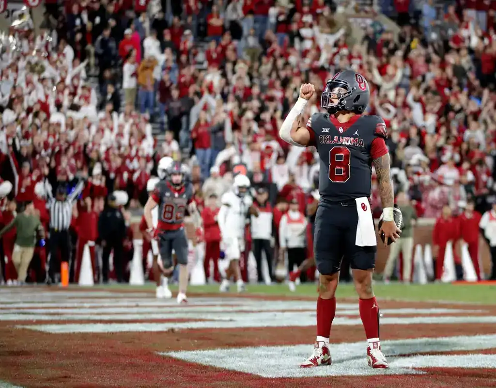 Oklahoma Sooners quarterback celebrates touchdown during game vs BYU Cougars on November 18, 2023