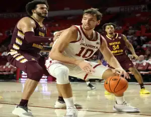 Oklahoma Sooners #10 dribbling against Mississippi Valley State Delta Devils defender #0 on the court