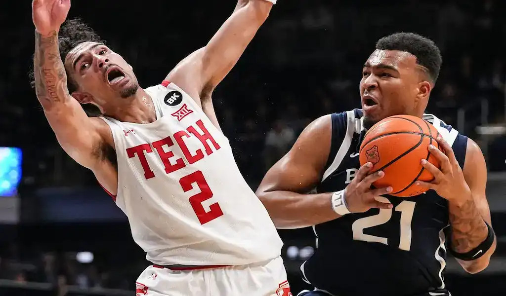 Butler Bulldogs guard drives to the basket while being fouled by a Georgetown Hoyas defender during an NCAA basketball game on December 19, 2023.
