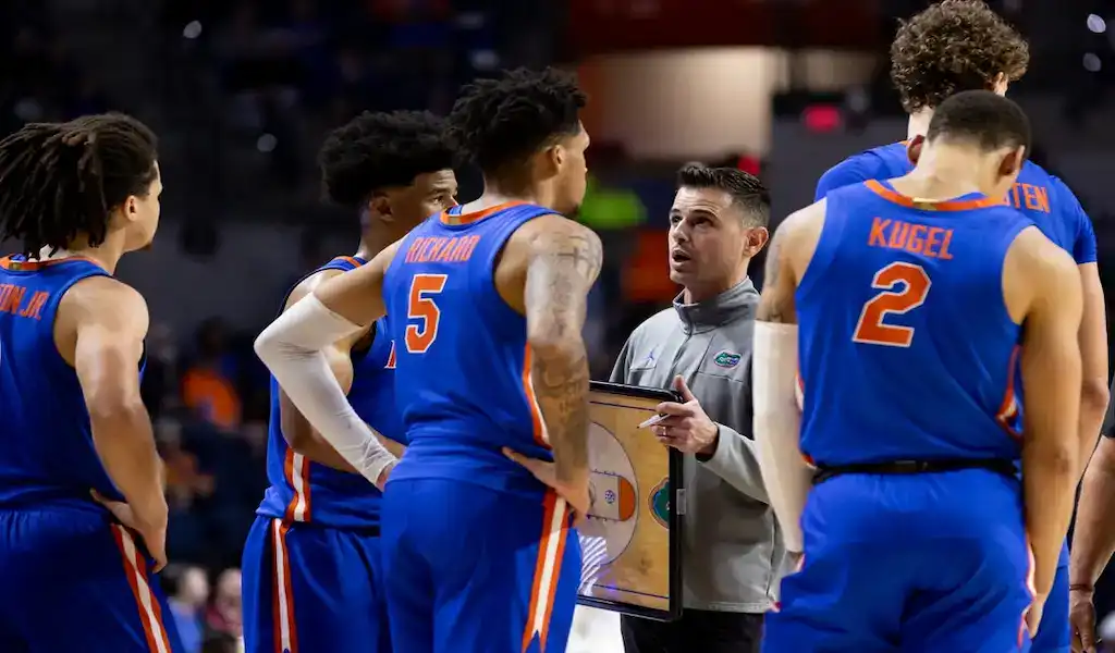 Florida Gators huddle with coach giving instructions during game against Richmond Spiders, December 9, 2023.