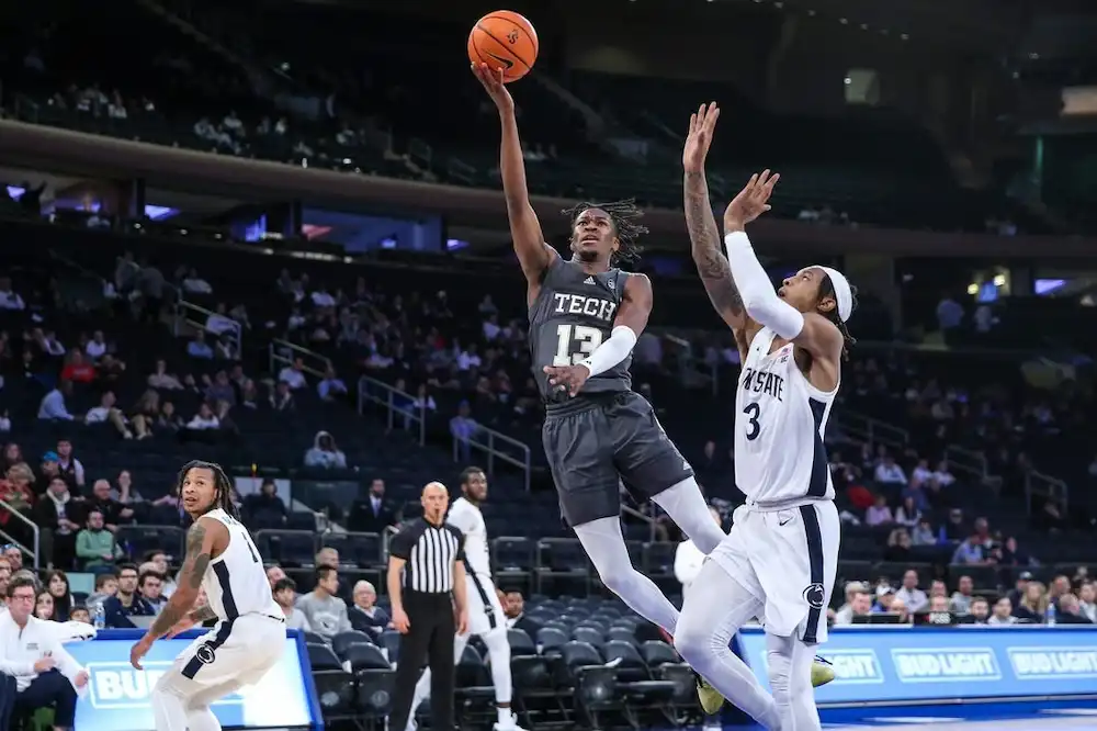 Georgia Tech player goes up for a layup while being defended by a player.
