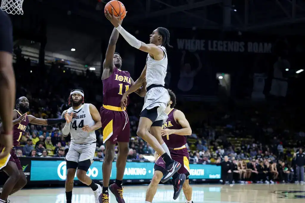 Player drives to the basket against Iona defender.