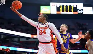 Syracuse Orange player going up for a layup against LSU defenders during a college basketball game.