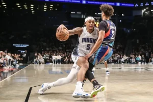 An Orlando Magic player drives aggressively toward the basket.