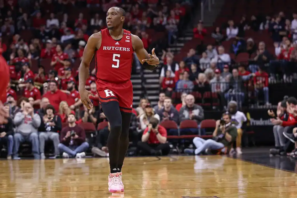 Rutgers basketball player #5 dribbling the ball during a game.