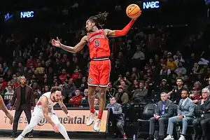 St. John’s player leaps in midair with ball.